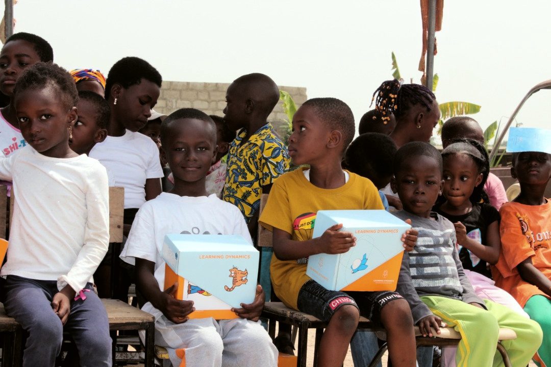 Children holding their reading kits close
